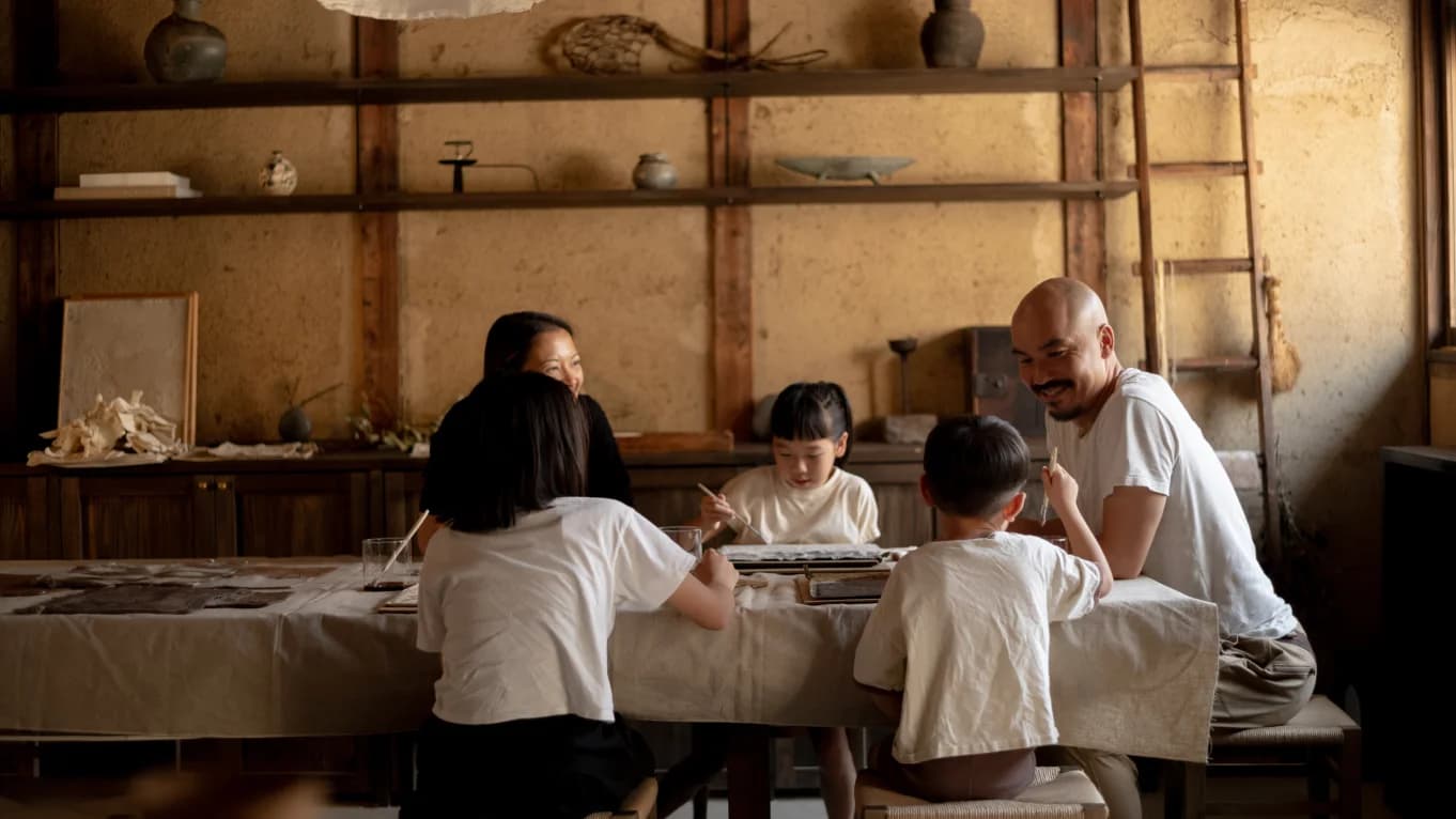 Family working on tea-dye around a table