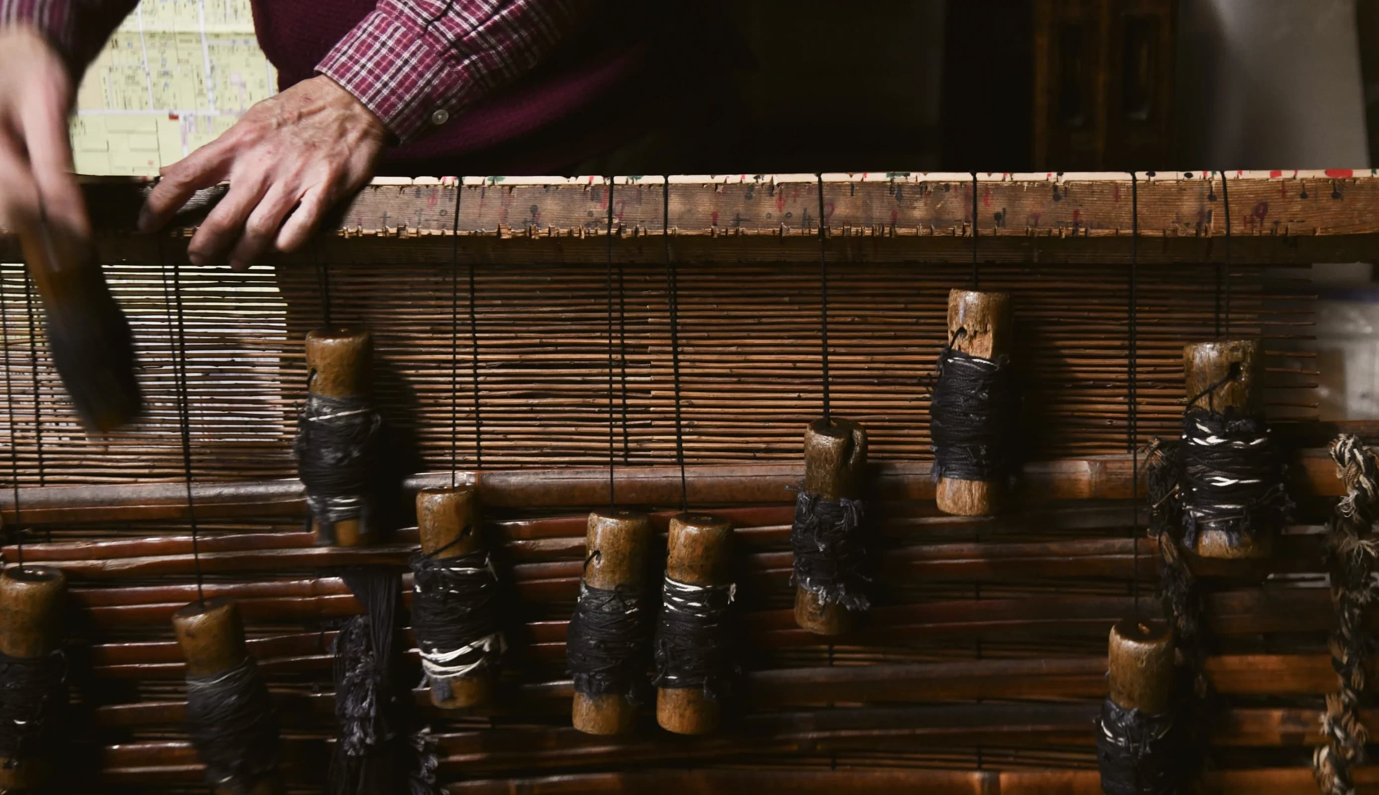 Wall of a traditional Japanese building seen through fall foliage.