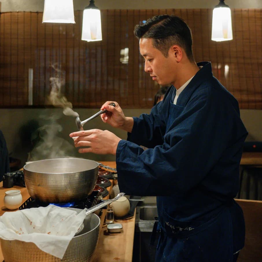 An artisan engraving a knife