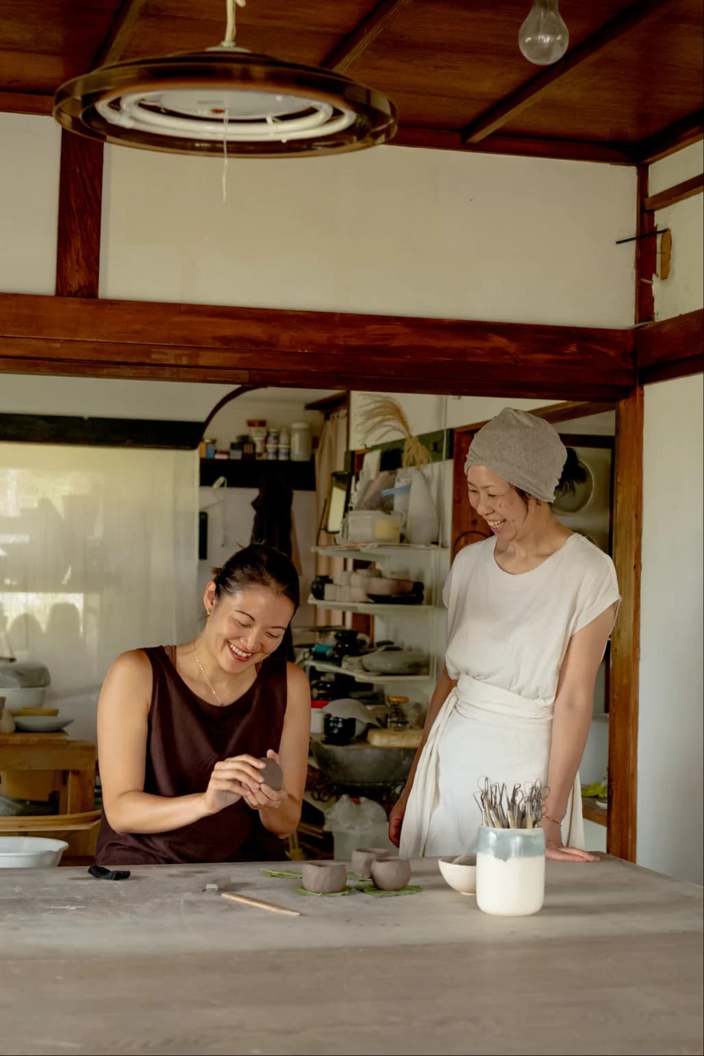 Potters working together to shape clay