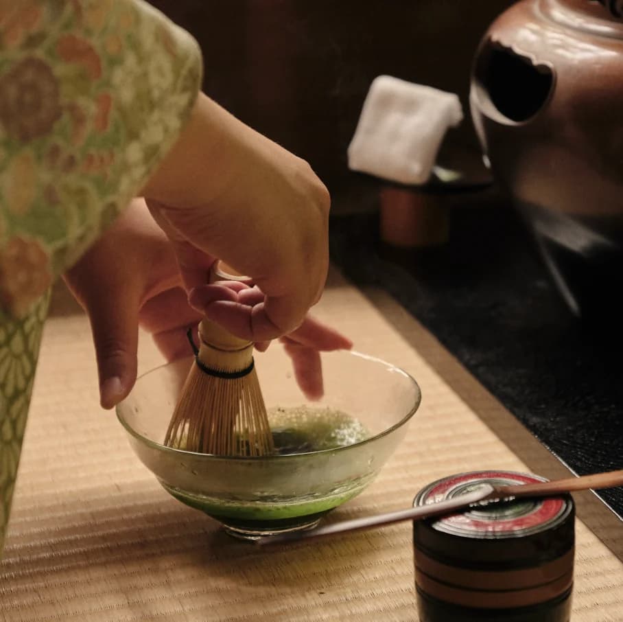 Tea preparation tools arranged on wooden surface