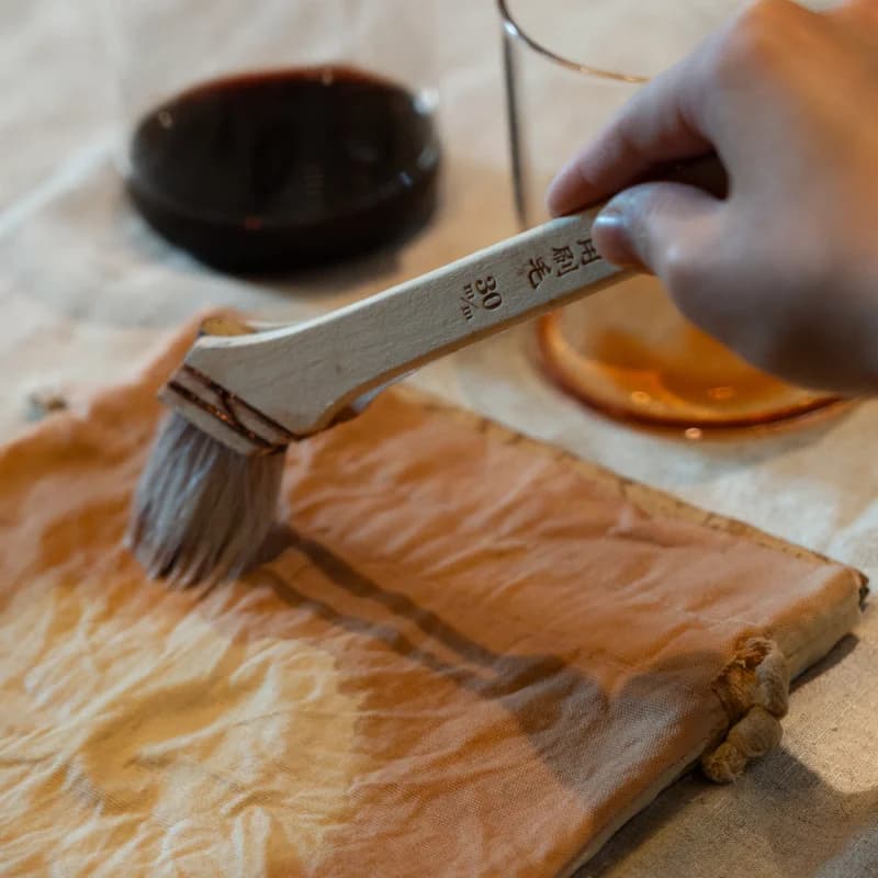 Pouring fermented amazake from a glass carafe