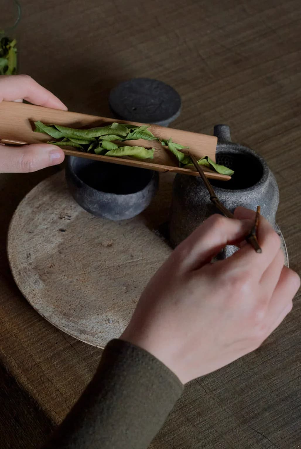 Hands performing tea ceremony rituals