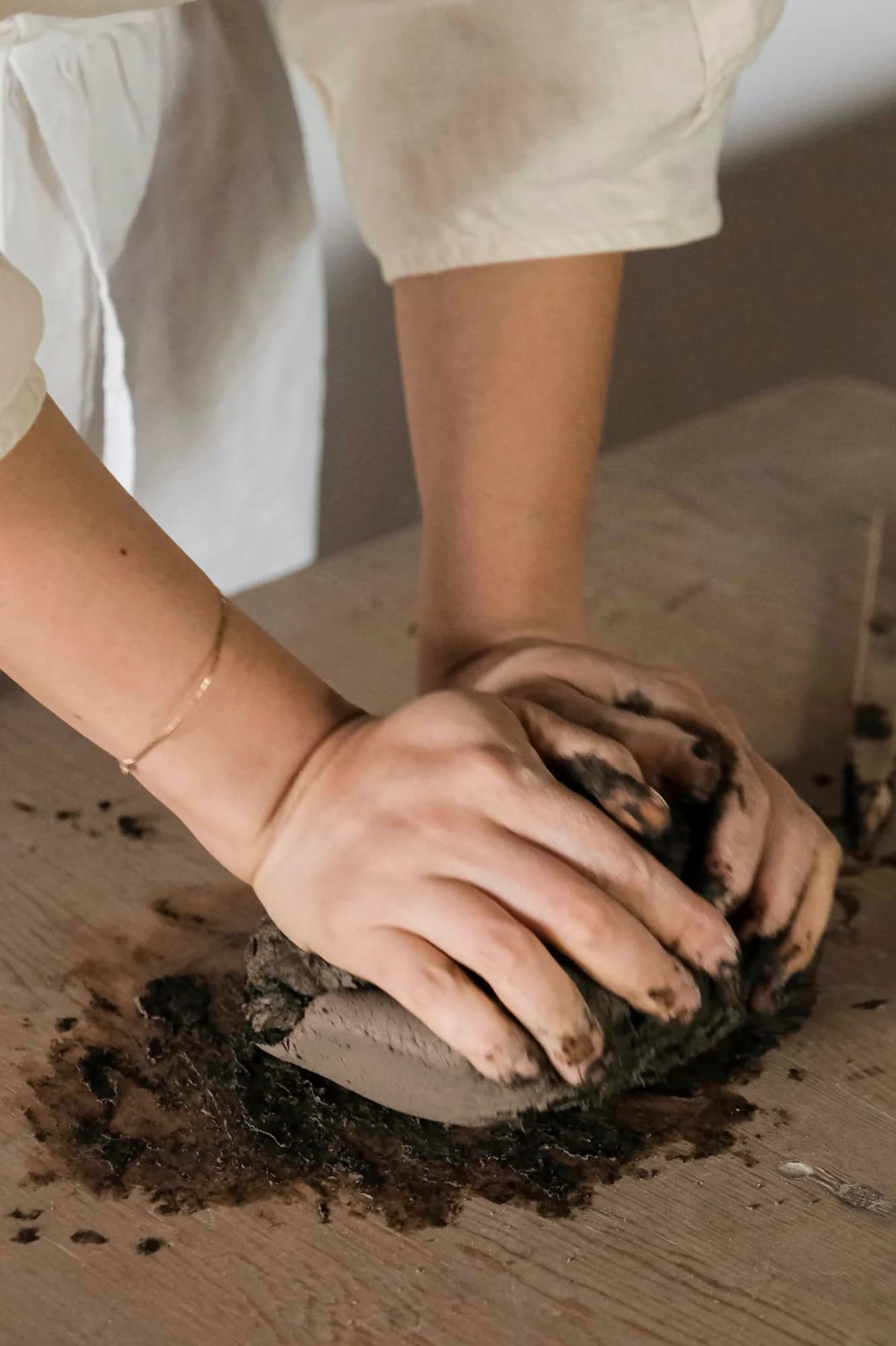 Potter demonstrating throwing technique at wheel