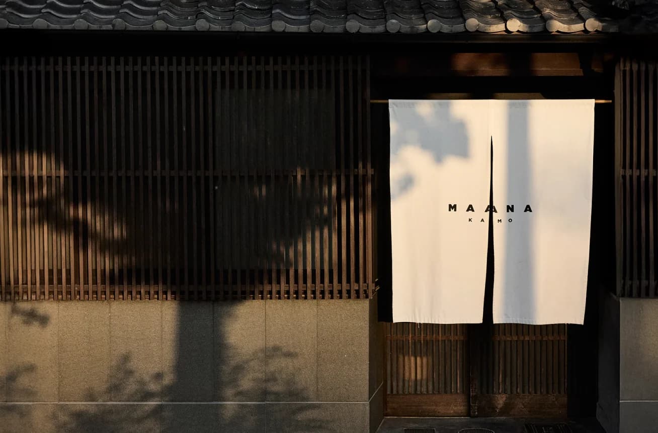 Maana Kamo exterior facade with noren curtain and wooden lattice